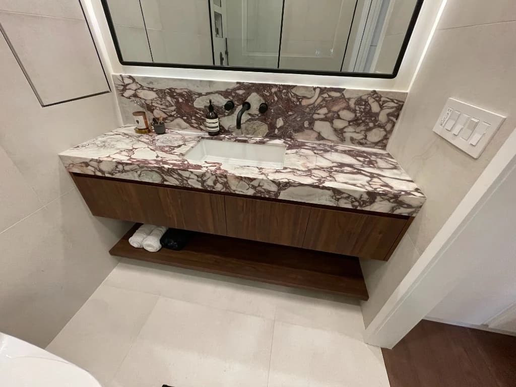 Luxury bathroom renovation with marble vanity and floating cabinet in Toronto