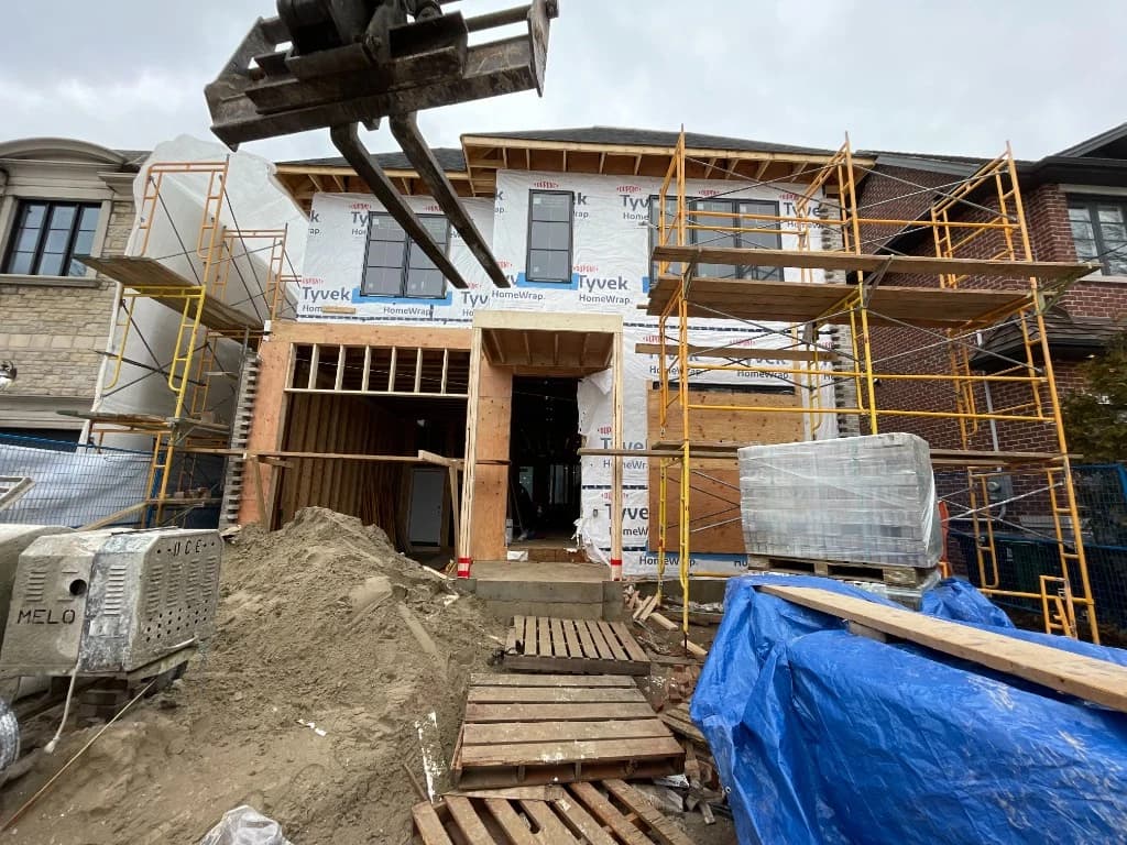 Custom home under construction with framing and Tyvek wrap in Toronto