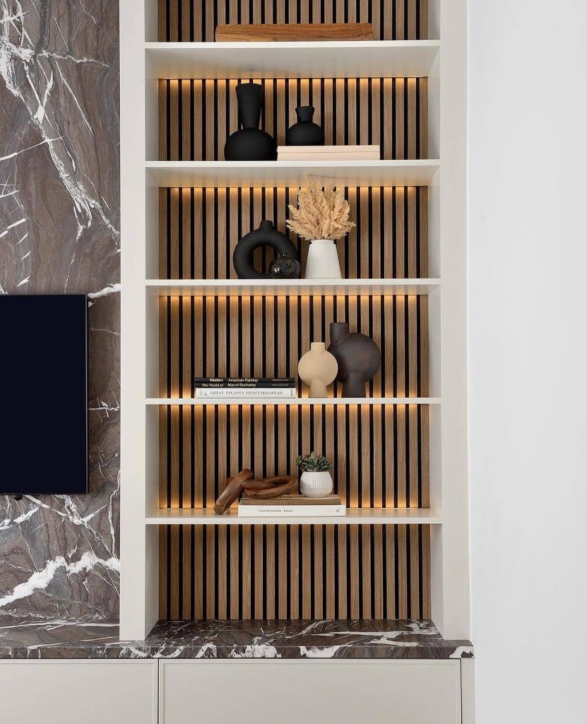 Custom built-in shelving with accent lighting in a Toronto home