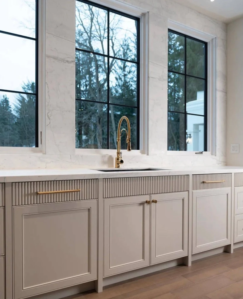 Luxury kitchen renovation with marble backsplash and gold fixtures in Toronto