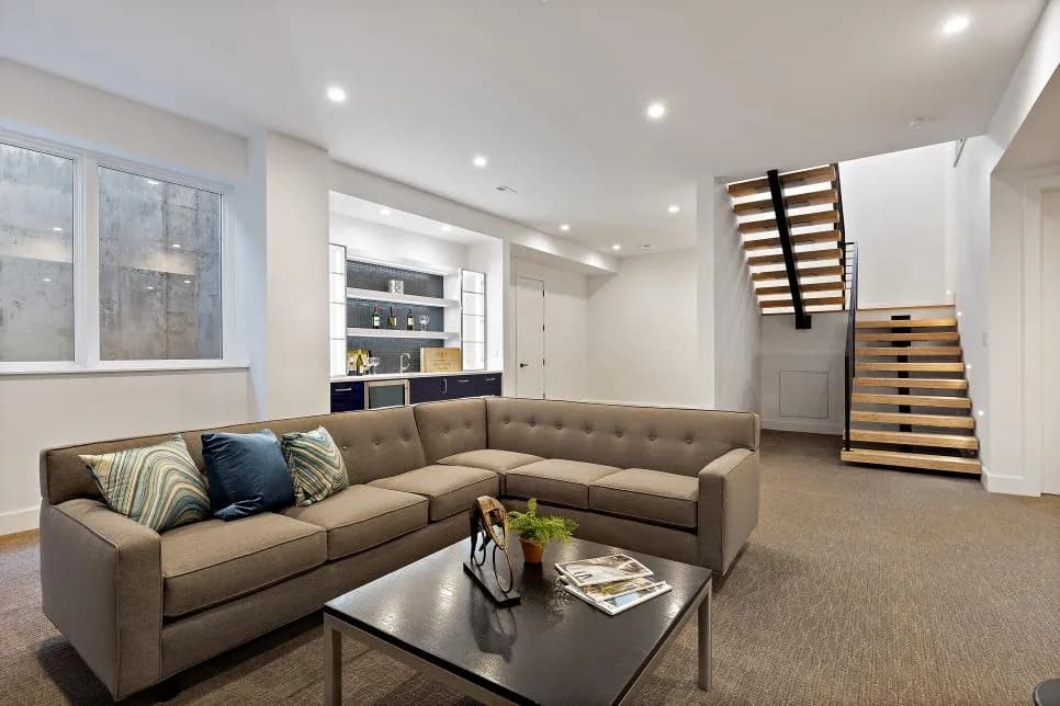 Finished basement living area with built-in bar and floating staircase in Lawrence Park, Toronto