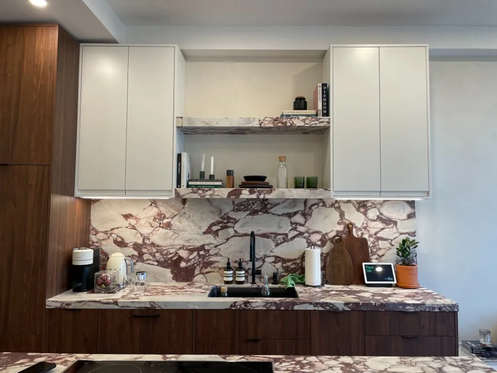 Condo kitchen renovation with viola marble backsplash, walnut base cabinets, and white wall cabinets in North Toronto, Toronto