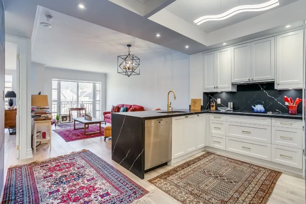 Open-concept condo renovation with kitchen, living area, and balcony doors in North Toronto, Toronto