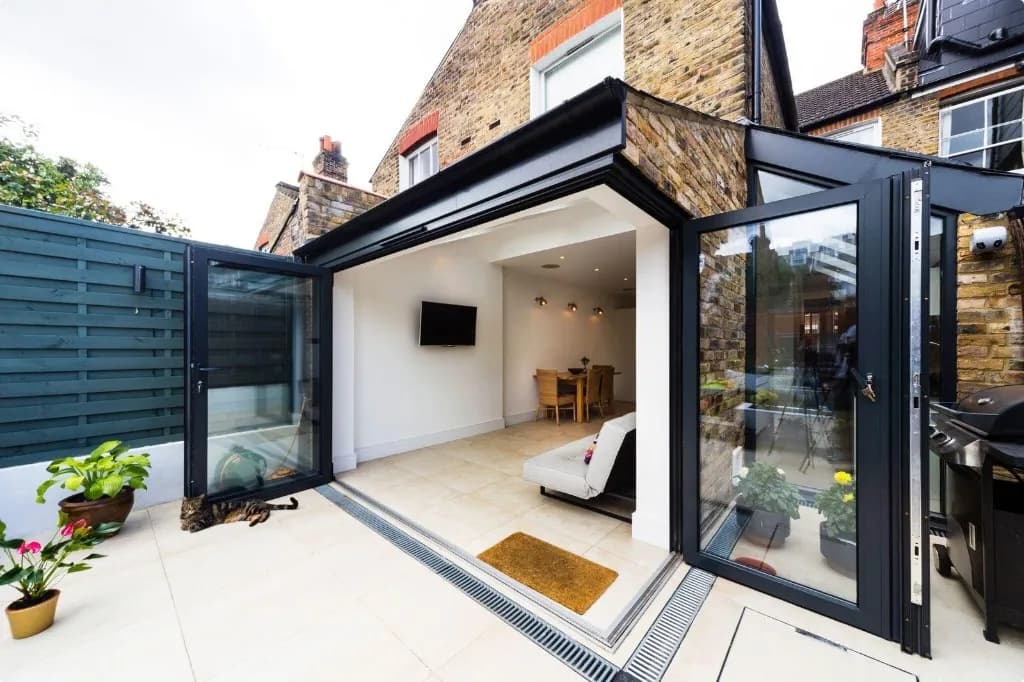 Rear home addition with glass bifold doors and patio in Leaside, Toronto